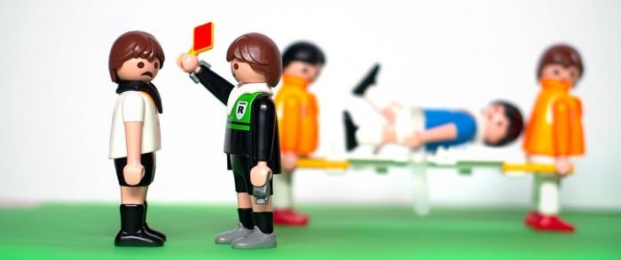 Photo of Lego soccer scene with player receiving a red card from the referee
