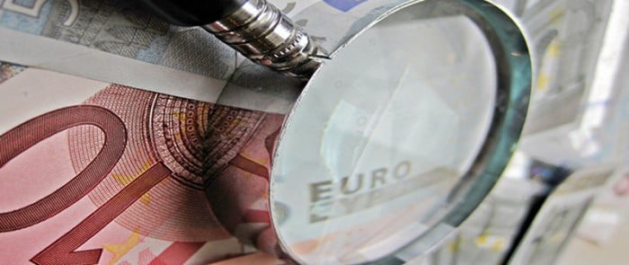 Magnifying glass on top of euros