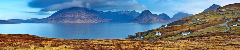 Panoramic view of the The Black Cuillin and the Village of Elgol Scotland 960x200